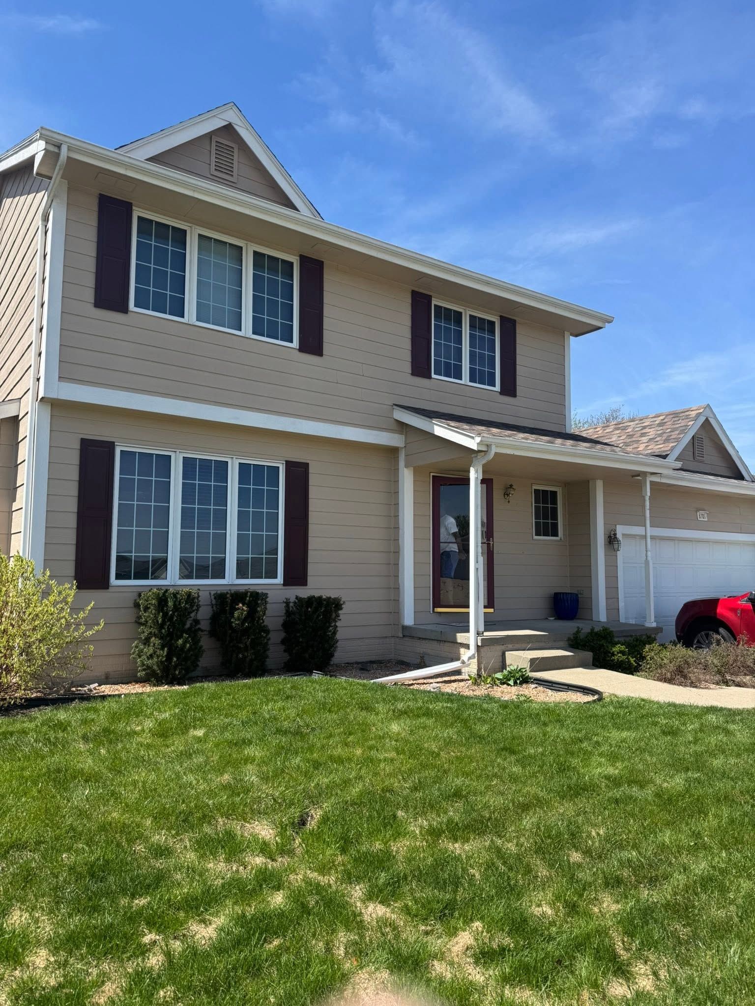 Newly installed vinyl siding on a two-storey residential home in Granger Iowa showing clean horizontal panel alignment
