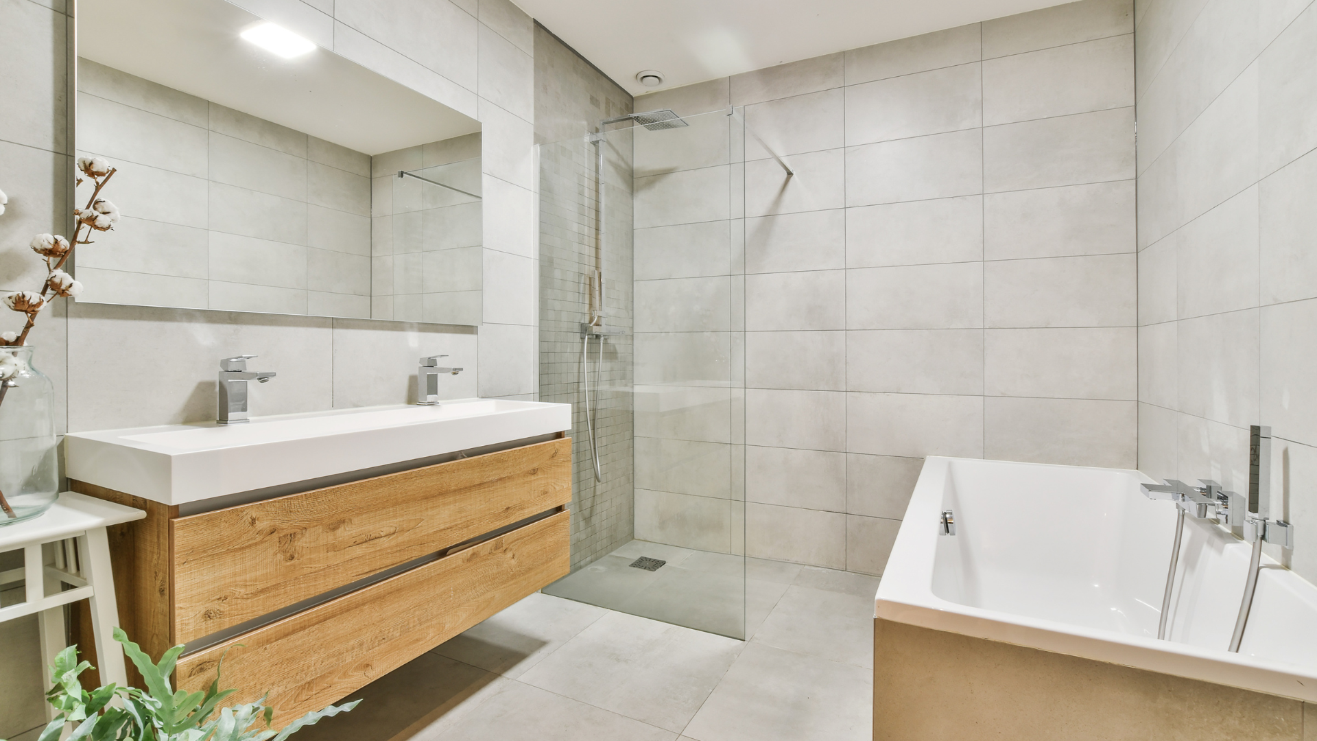 Kitchen undergoing renovation, walls partially open, exposing studs and pipes. A ladder leans against the wall.