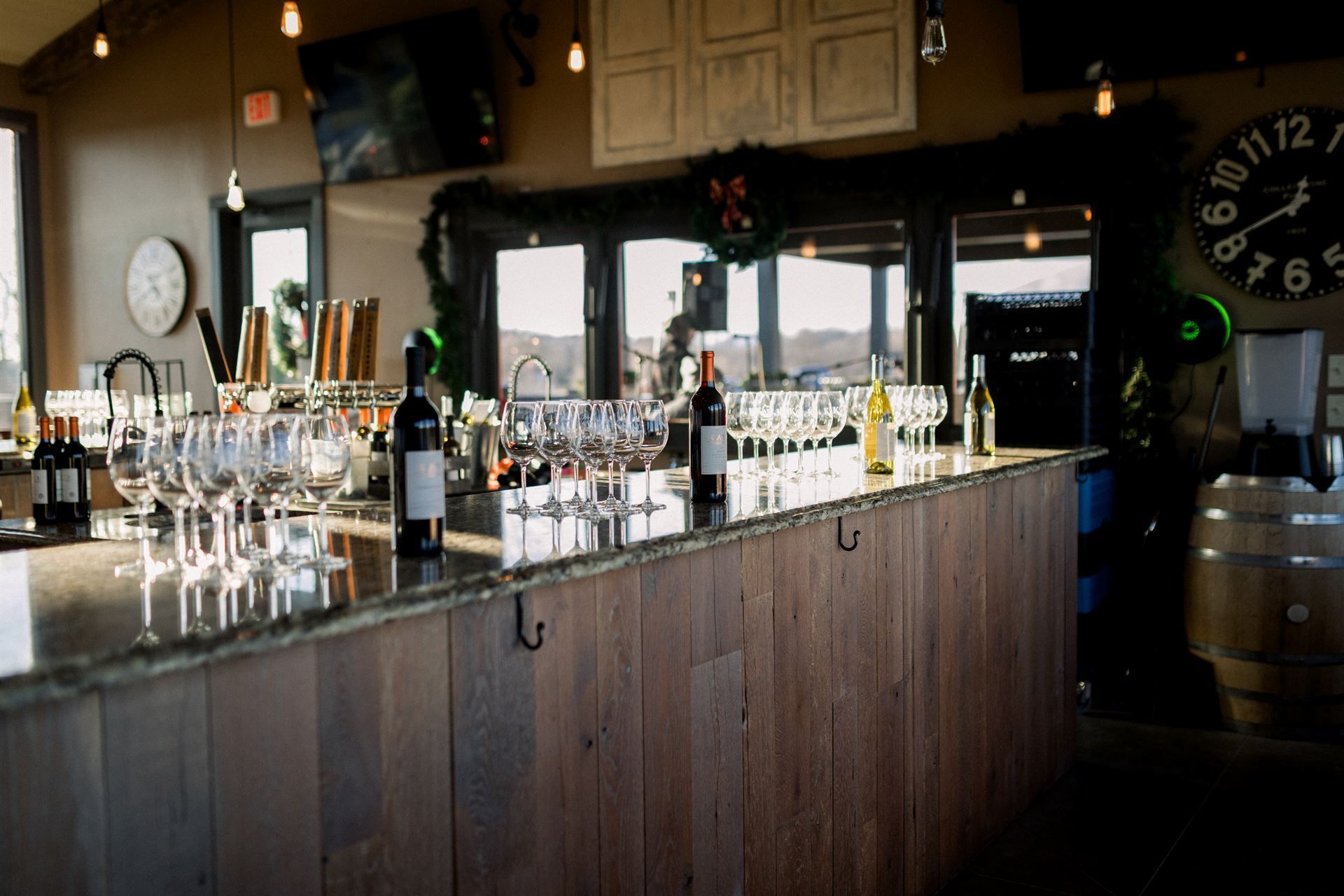 Wine bar interior with glasses, bottles, and a wooden counter.
