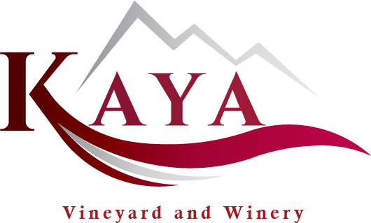 A logo for kaya vineyard and winery with a mountain in the background