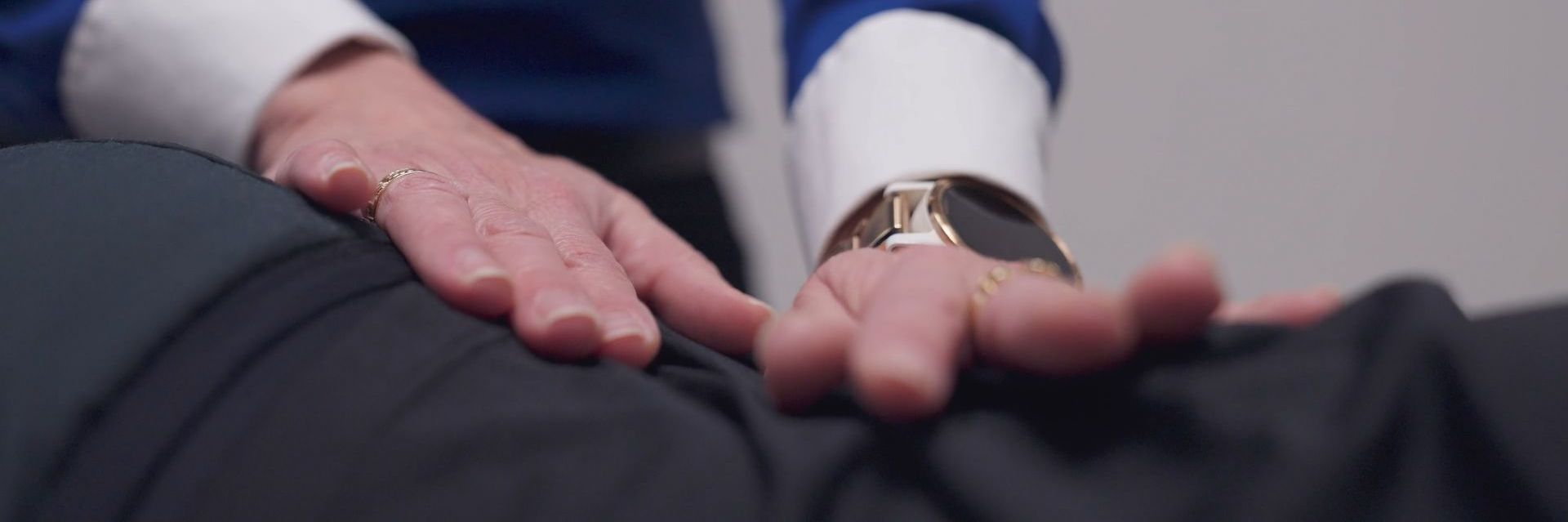 A close up of a person 's hands on a person 's back.