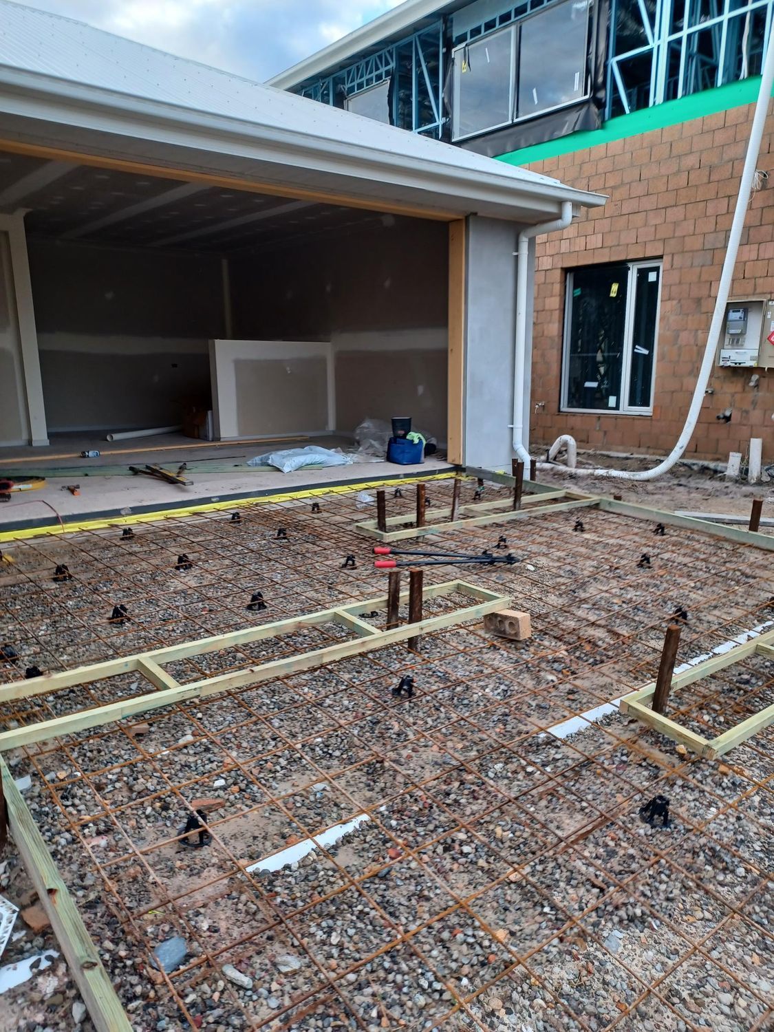 Construction Site With Rebar, Wooden Frames, and Vertical Pipes — DPC Decorative Patterned Concrete in Sunrise Beach, QLD