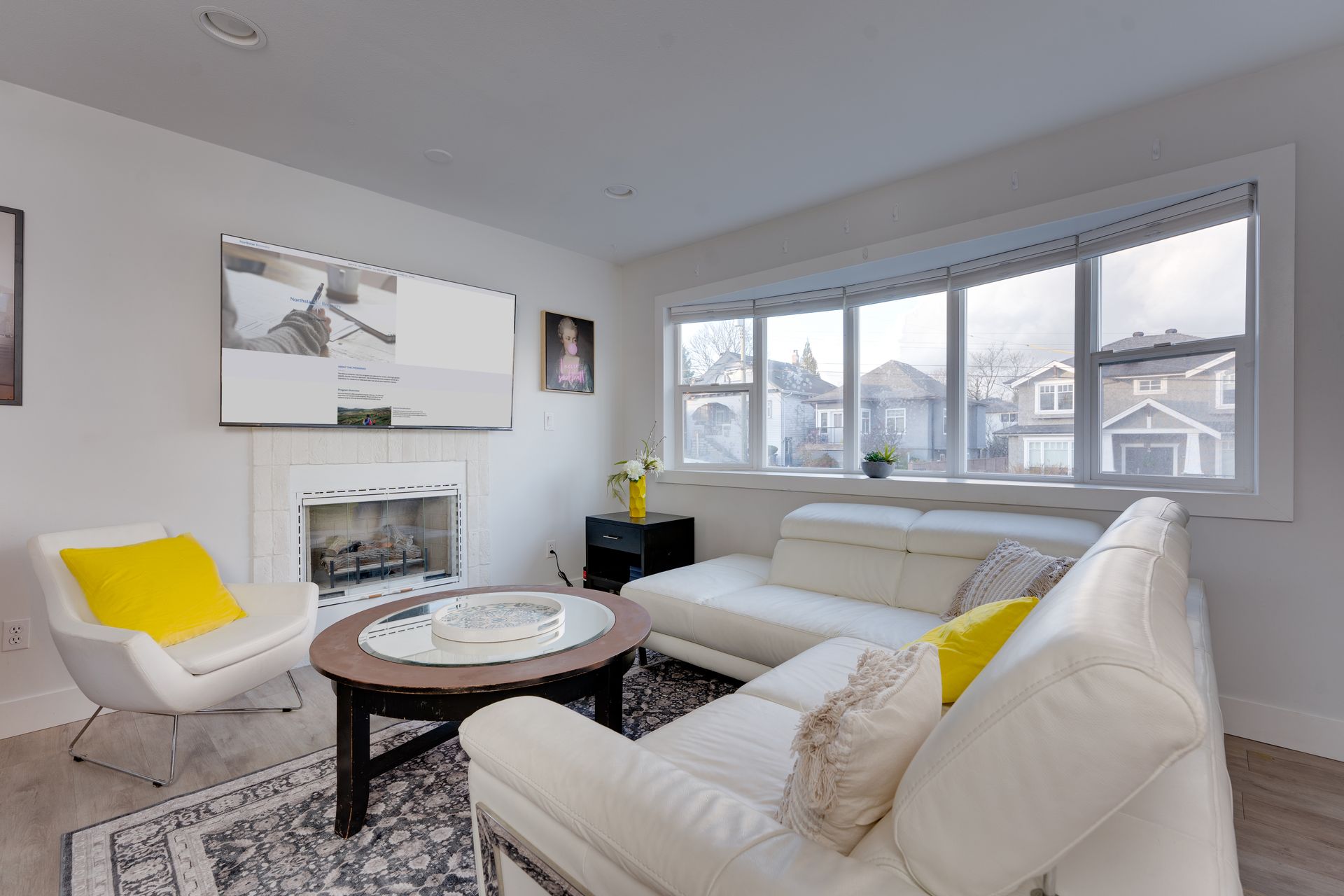A living room with a couch , chair , coffee table and fireplace.
