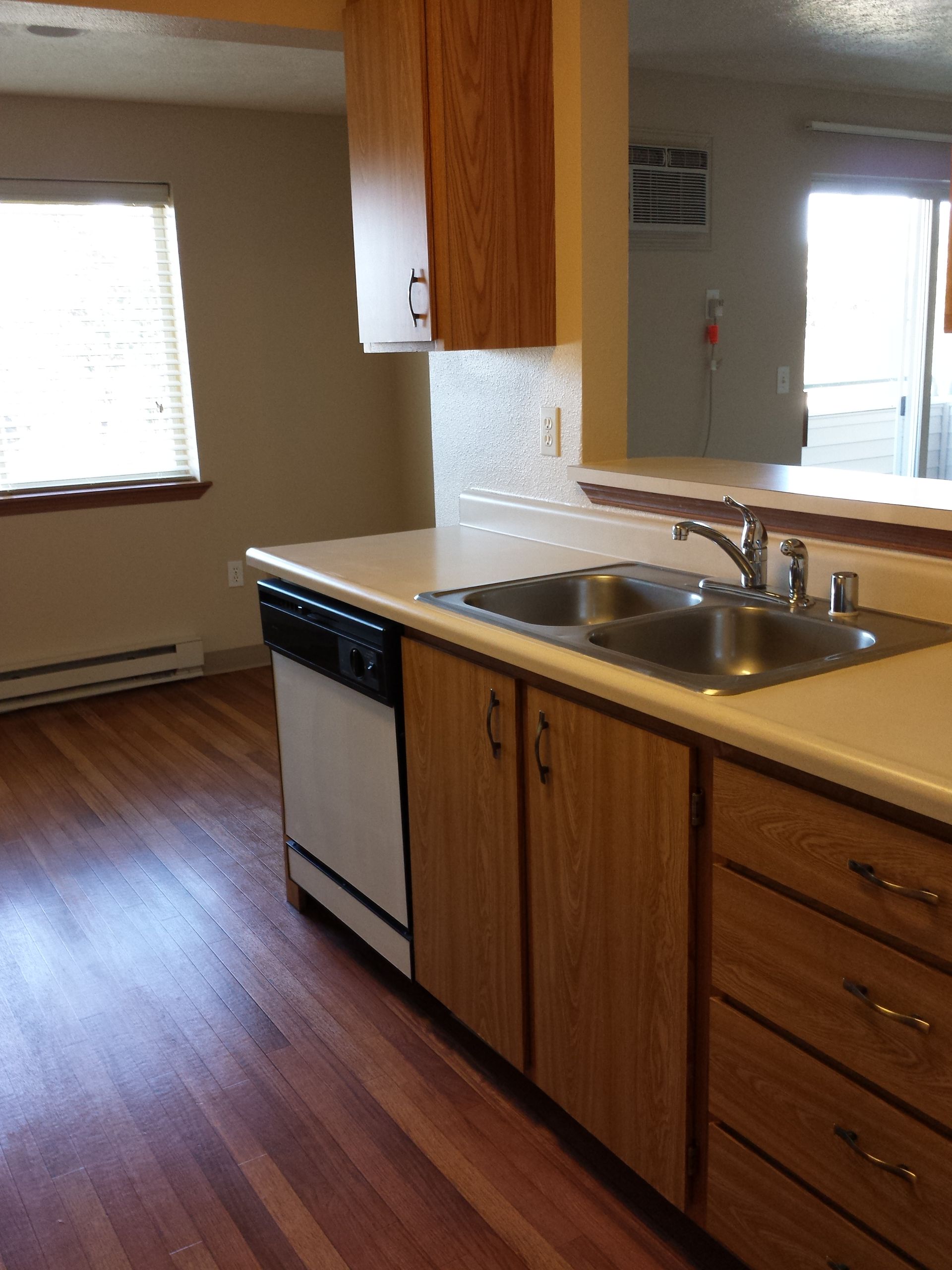 A kitchen with wooden cabinets and a sink