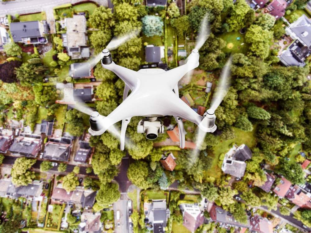 White Drone Hovering Over a Green Residential Neighborhood — Environment Restoration Solutions in Waterview Heights, NSW