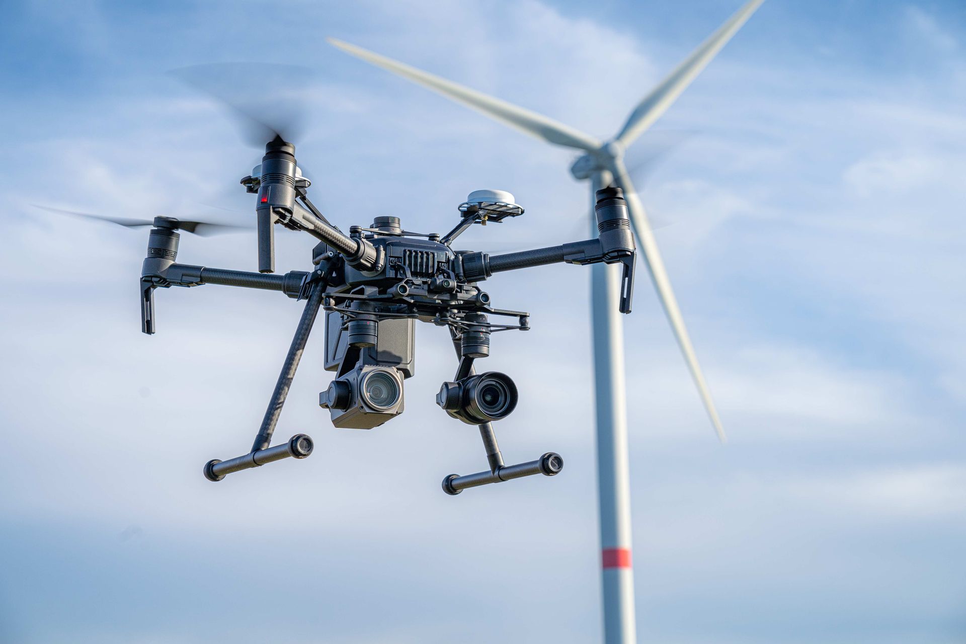 Drone Flying Near a White Wind Turbine Against a Blue Sky — Environment Restoration Solutions in Waterview Heights, NSW