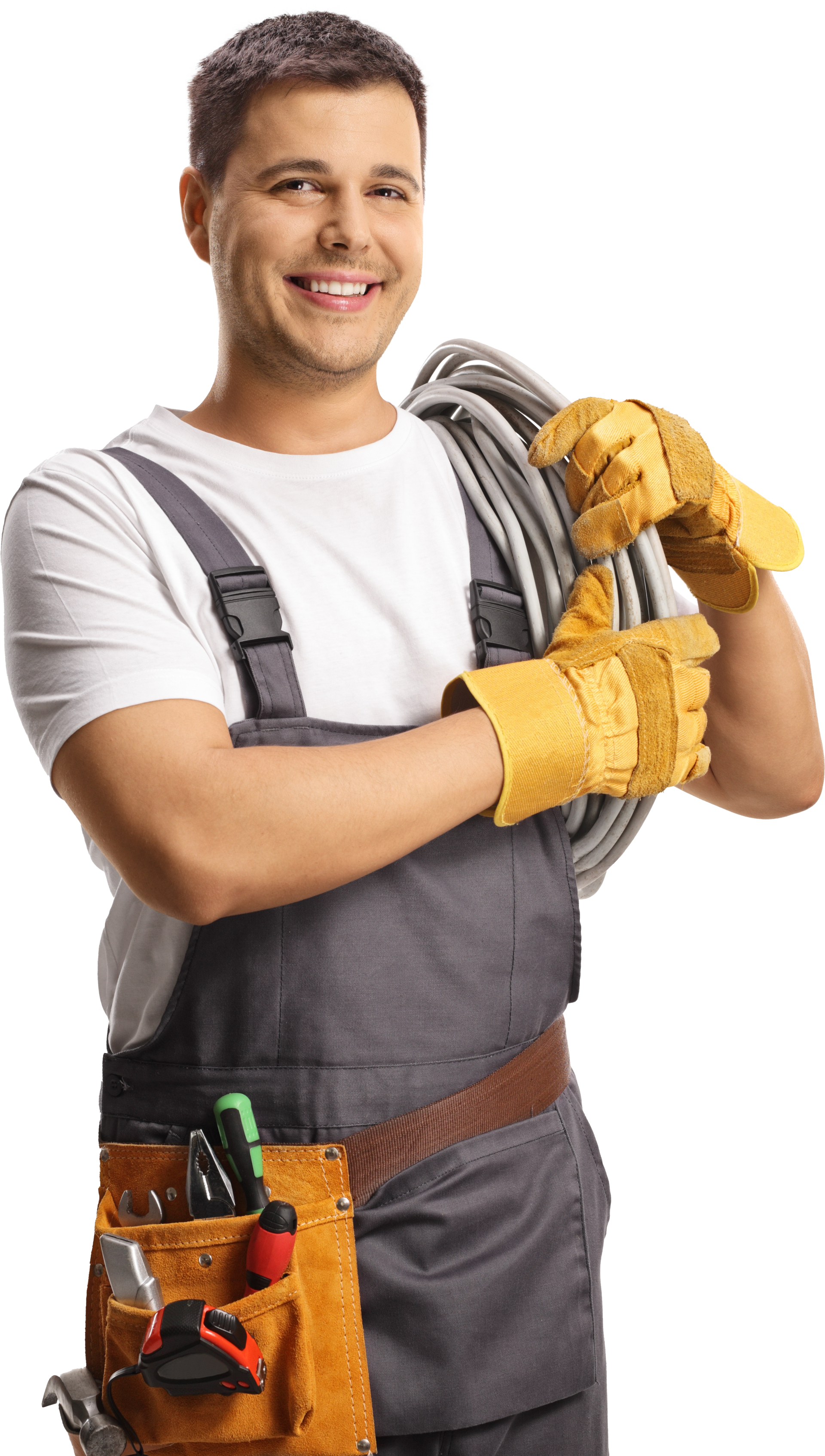Electrician in overalls with tools, holding wire, smiling.