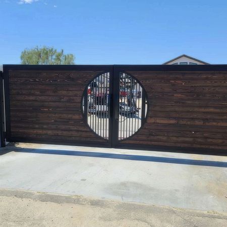 A wooden gate with a round hole in the middle