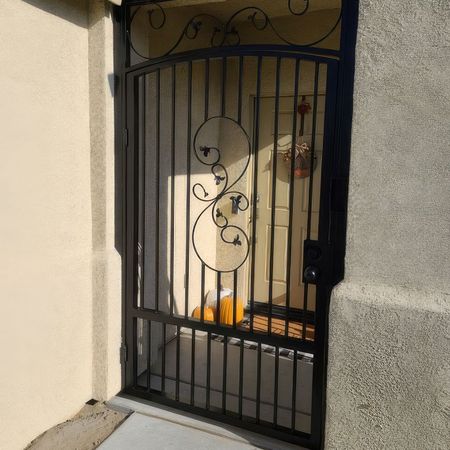 A wrought iron gate with a swirl design on it