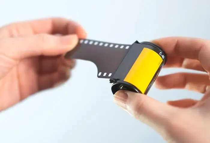 A person holding a roll of film