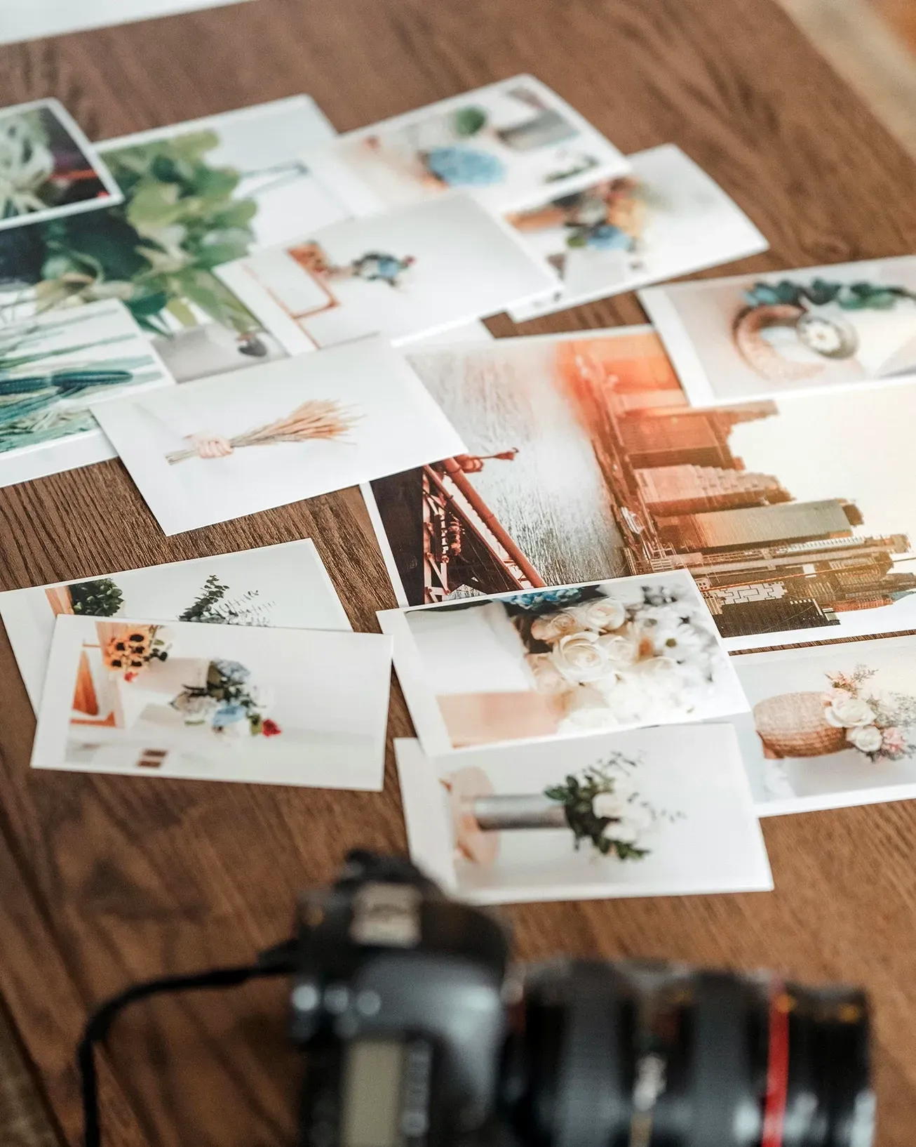 Multiple high-quality 8x10 cheap photos with white borders on a wooden table
