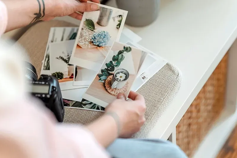 A person looking through their photo prints