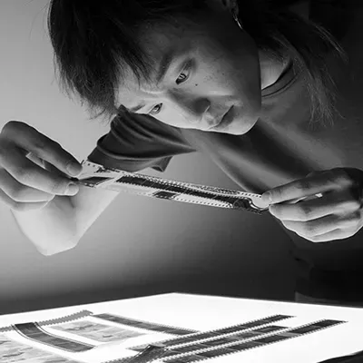 Professional examining strip of film
