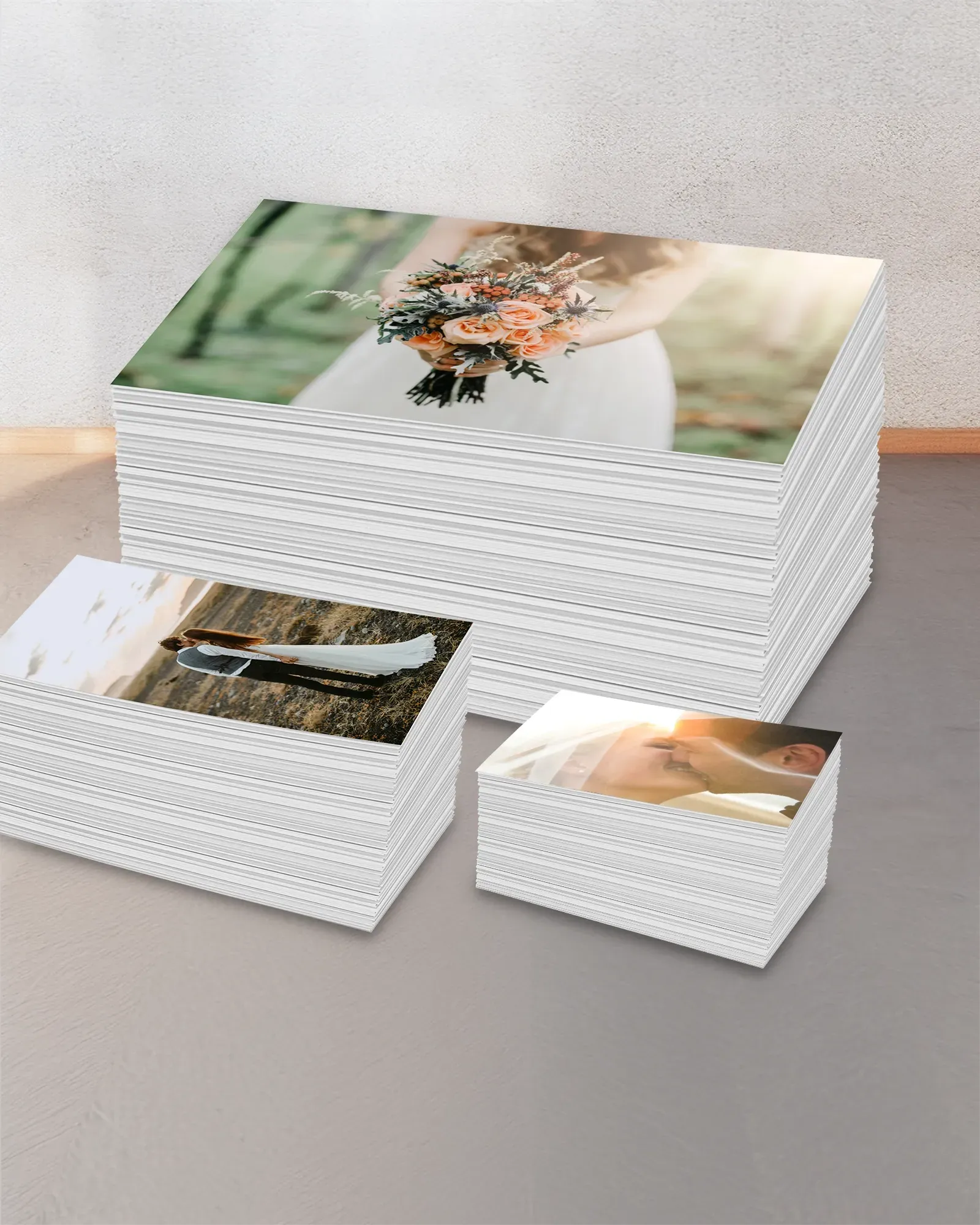 Three stacks of bulk photo prints
