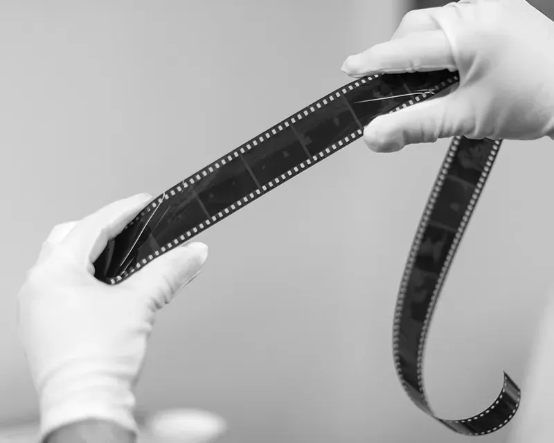 film developing White gloves holding a roll of film