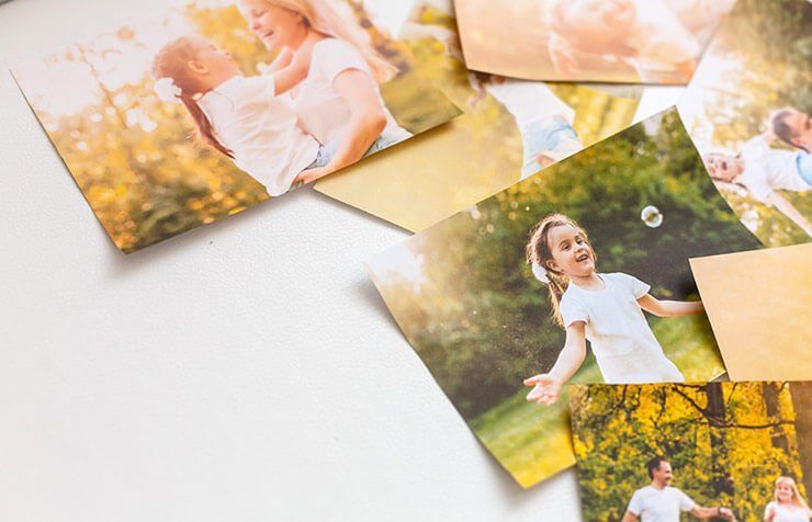 A variety of 8x10 photo prints on a table