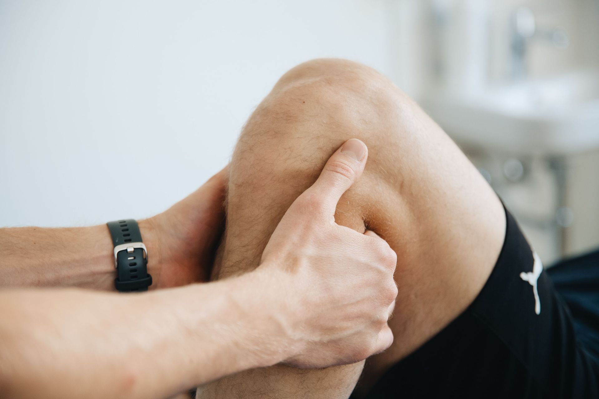 A patient holding his knee after an injury