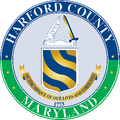 Harford County, Maryland seal: Blue and gold shield, sword, and quill,