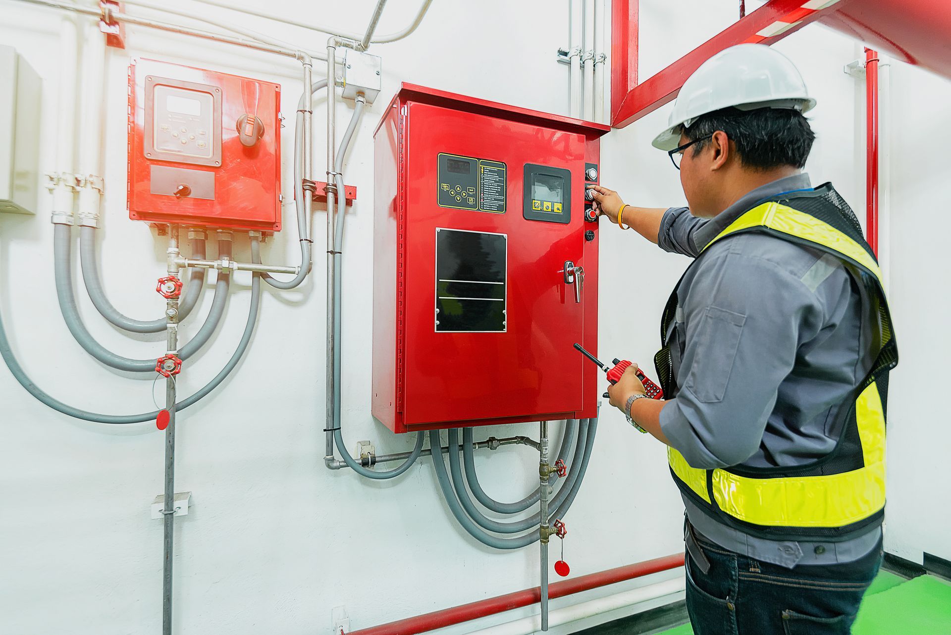 Fire protection inspection of fire alarm control panel by a technician.