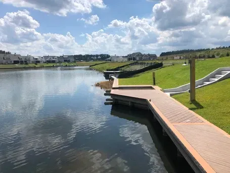 A large body of water with a dock in the middle of it