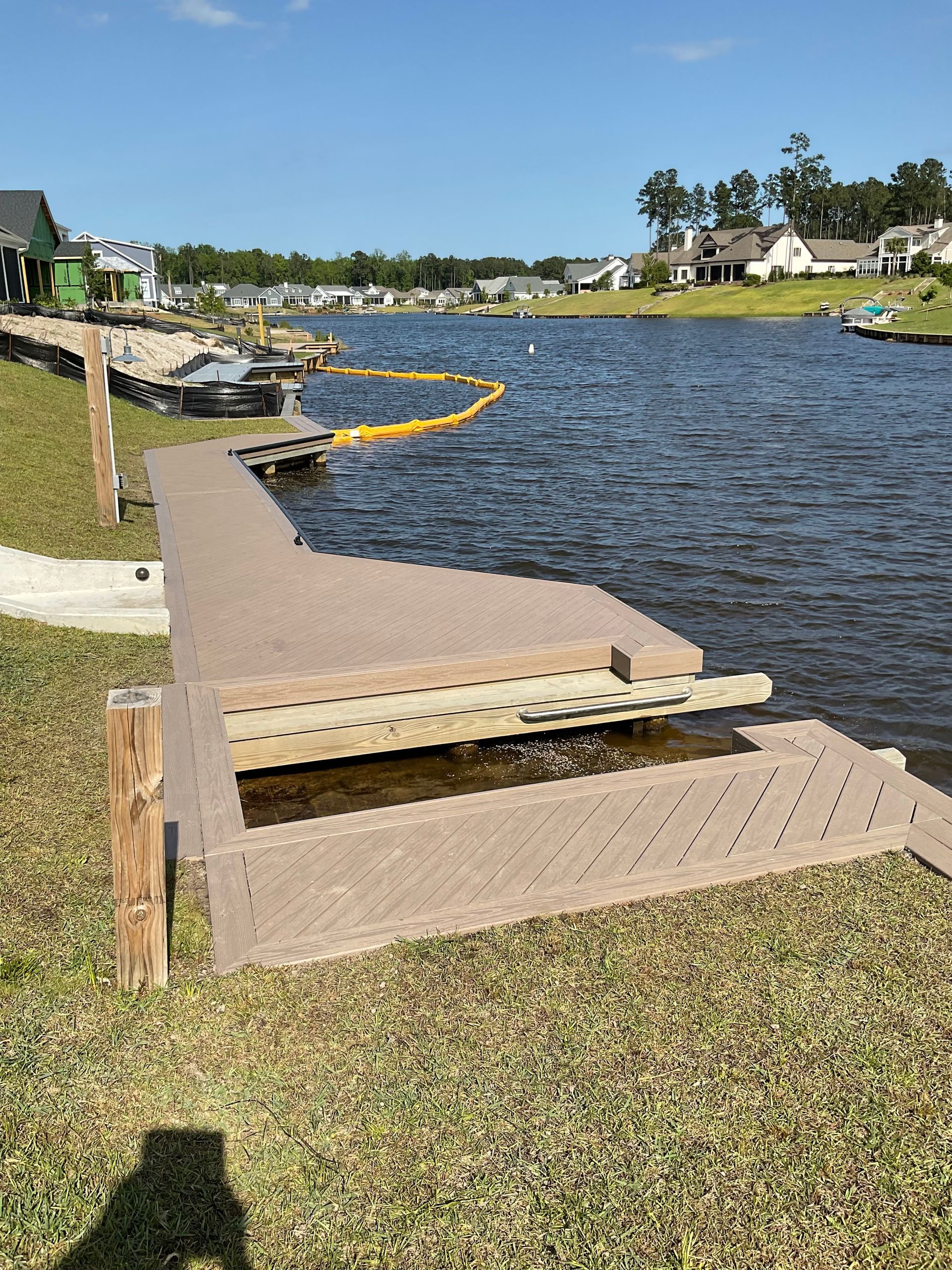 A dock is sitting next to a body of water.