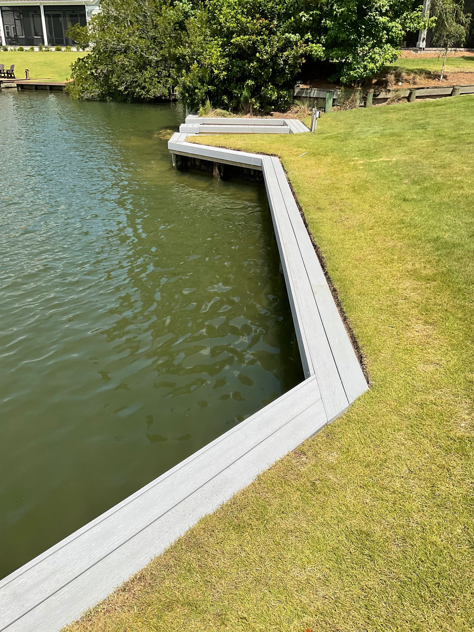 A dock is sitting next to a body of water.