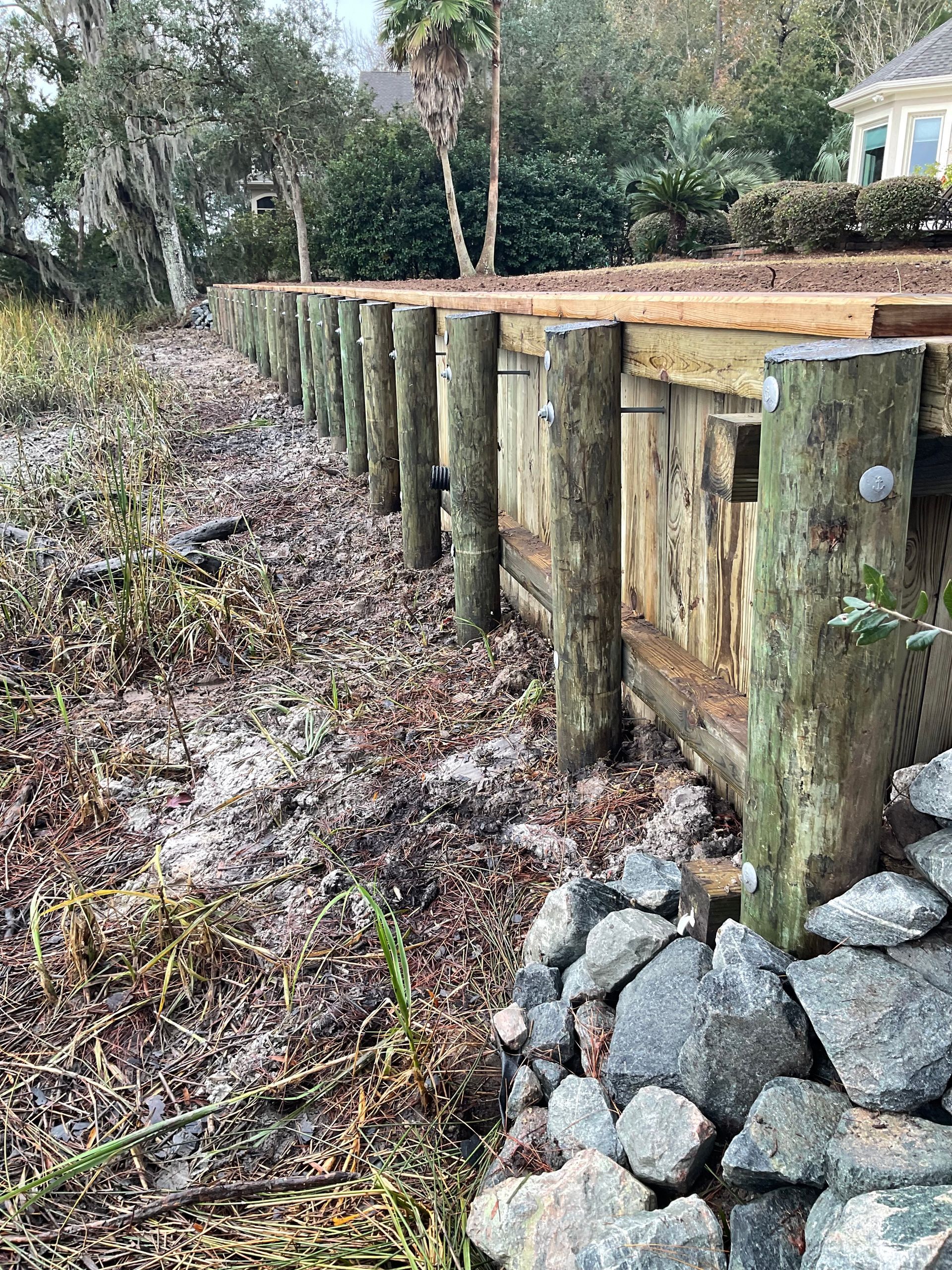 A wooden dock is being built on the shore of a lake.