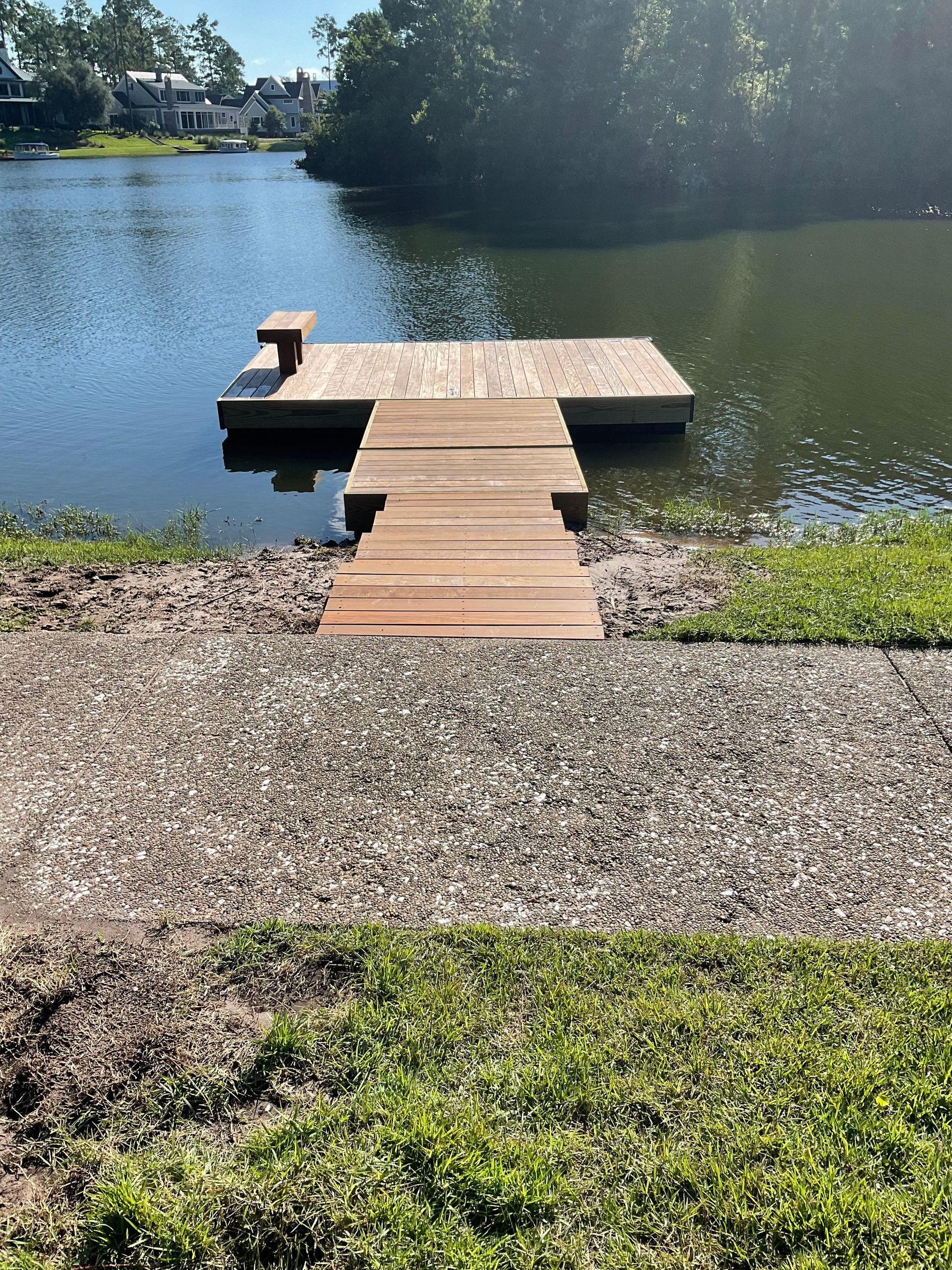 A wooden dock is sitting on the shore of a lake.