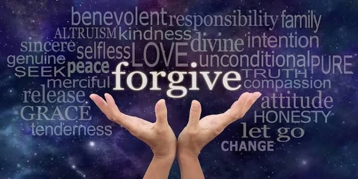 A pair of hands hold up a cloud of words against a night sky. Some of the visible words are forgive, truth, compassions, honestty, benevolent, responsibility, and selfless.