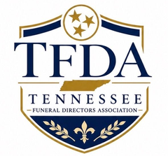 TFDA Tennessee Funeral Directors Association blue-and-gold shield logo with stars and laurel wreath