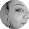 A black and white photo of a woman 's face in a circle.