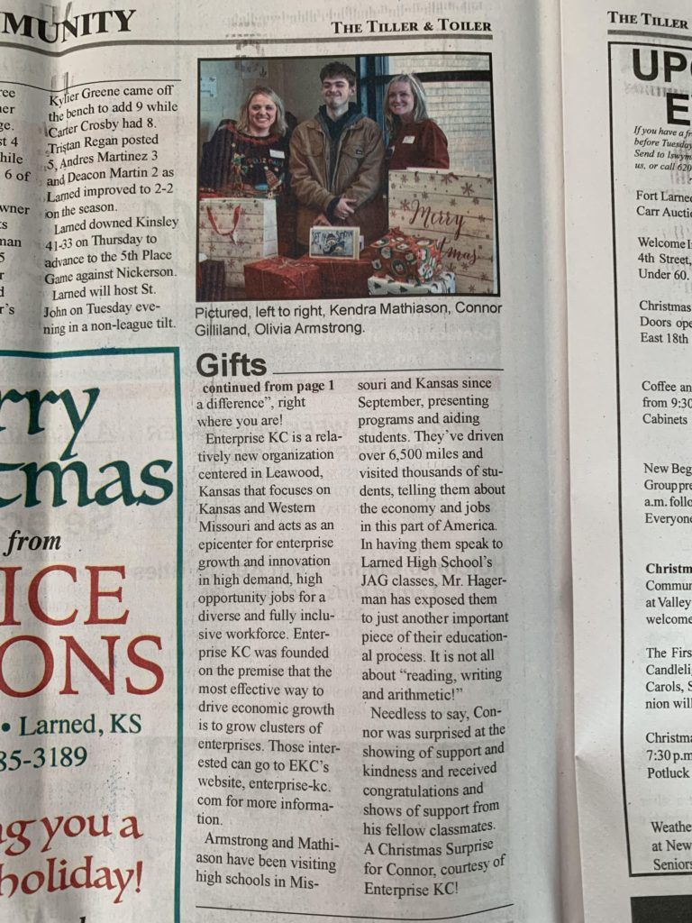 Newspaper page with a “Gifts” section and a small photo of three people in a holiday setting