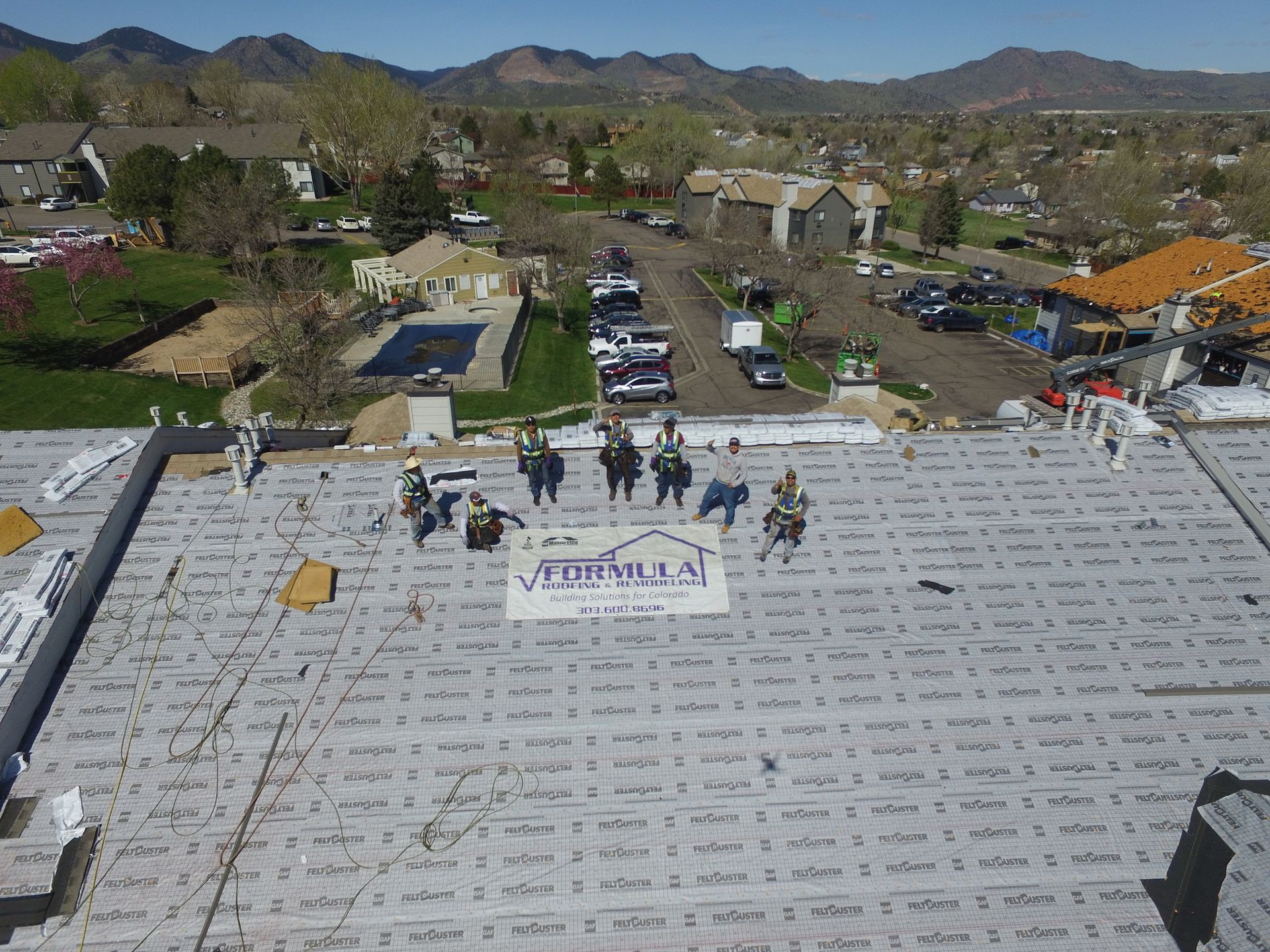 A group of people are standing on top of a roof.