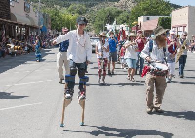 Picture of stilt walker with Community and Parade Band at Cherry Days