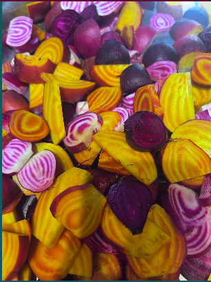 Mixed colorful candies with purple, yellow, and pink swirls piled together