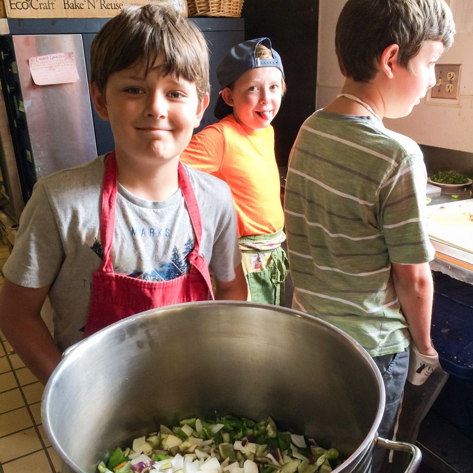 Three boys preparing lunch image