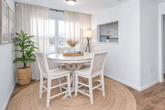 pensacola apartment dining room with hightop bar table, four chairs and plants