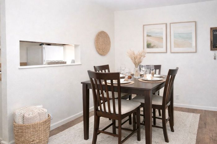 pensacola apartment dining room with hightop bar table, four chairs and plants