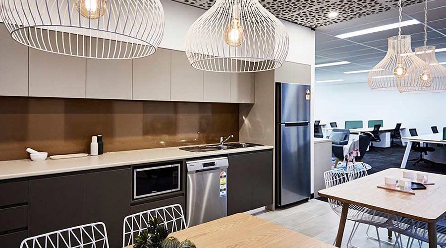 A kitchen with a table and chairs in it and a refrigerator.