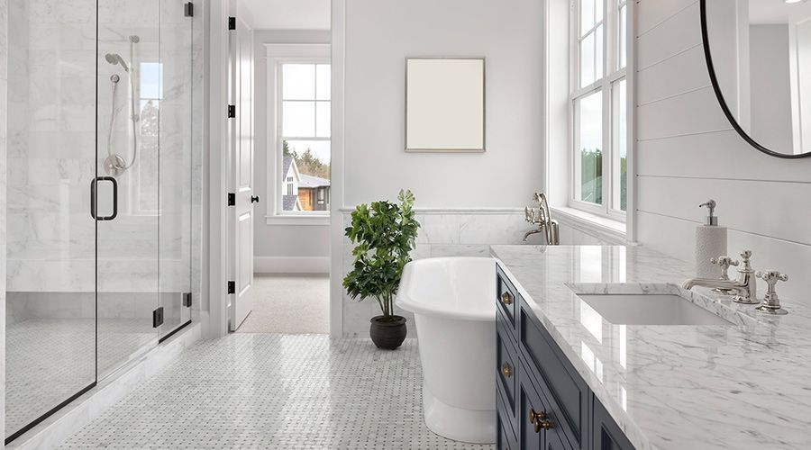 A bathroom with a tub , sink , and shower.