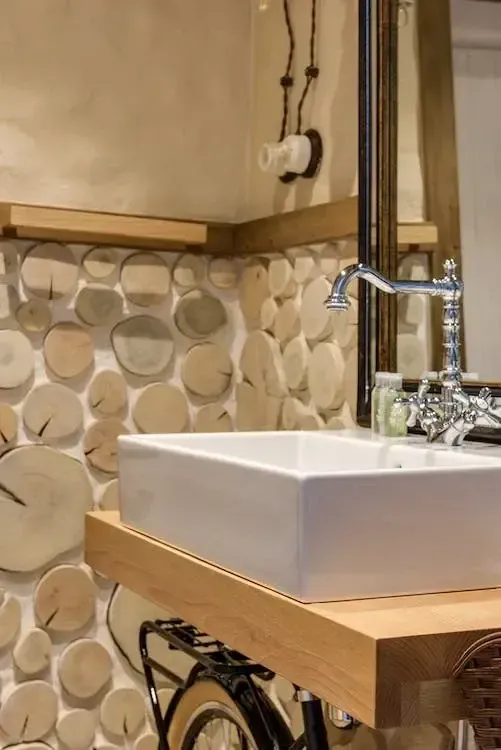 A bathroom with a sink and a clock on the wall