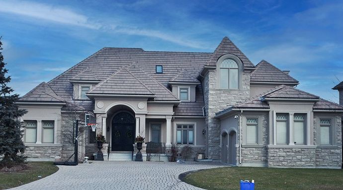 A large house with a blue sky in the background
