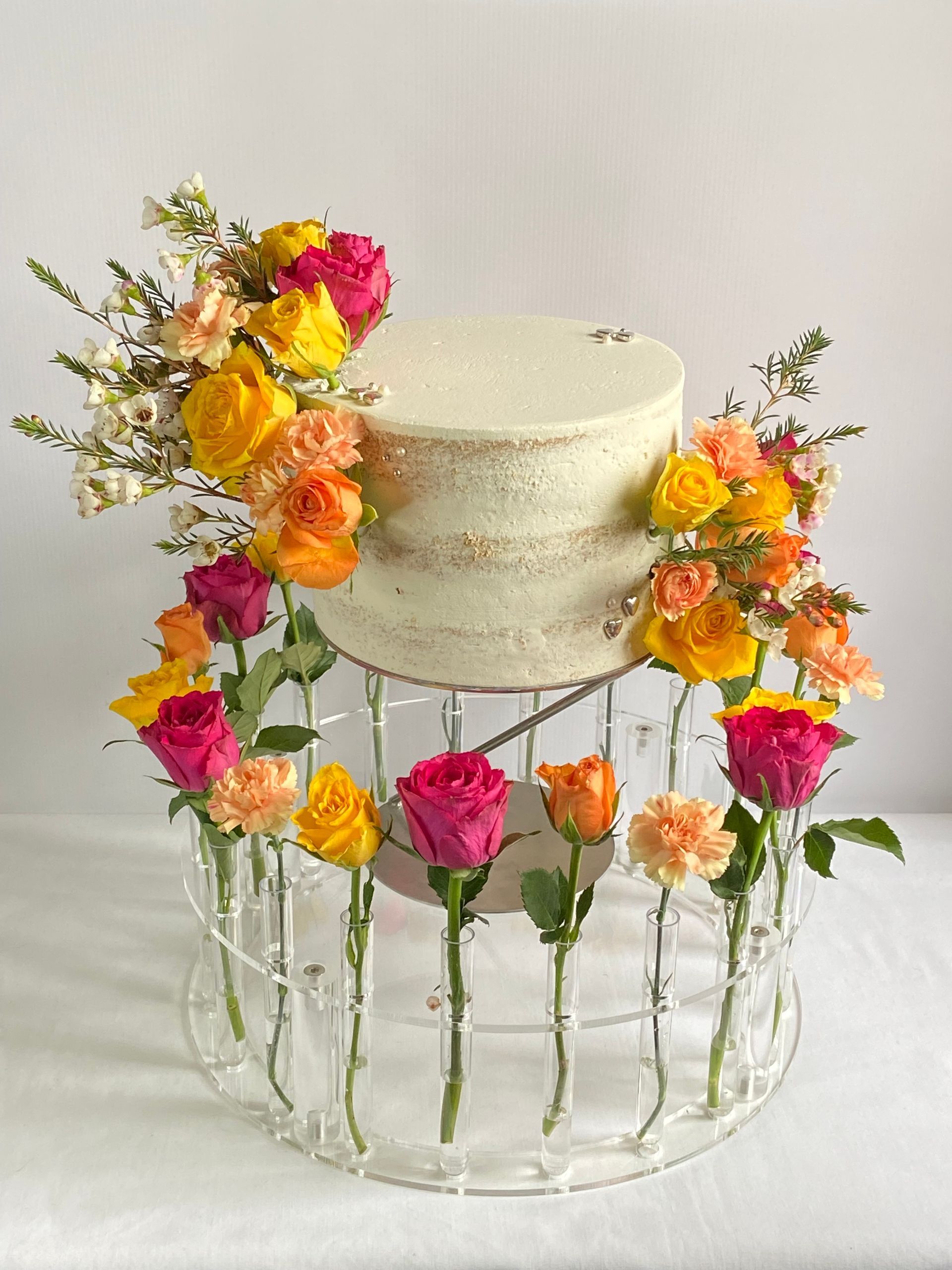 A cake with flowers on top of it on a table.