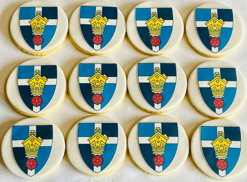 A bunch of cookies with shields and crowns on them