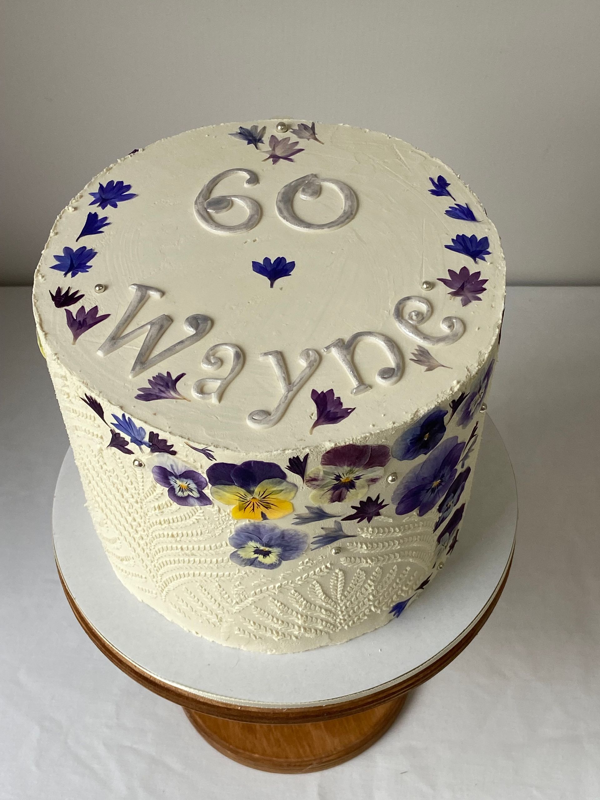A white cake with the name wayne on it