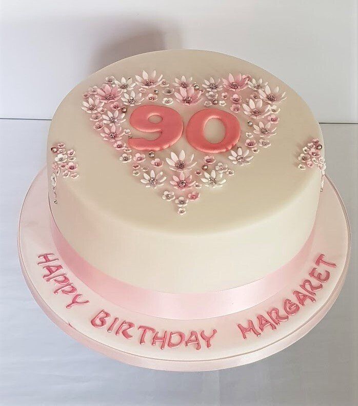 A birthday cake with the number 90 on it