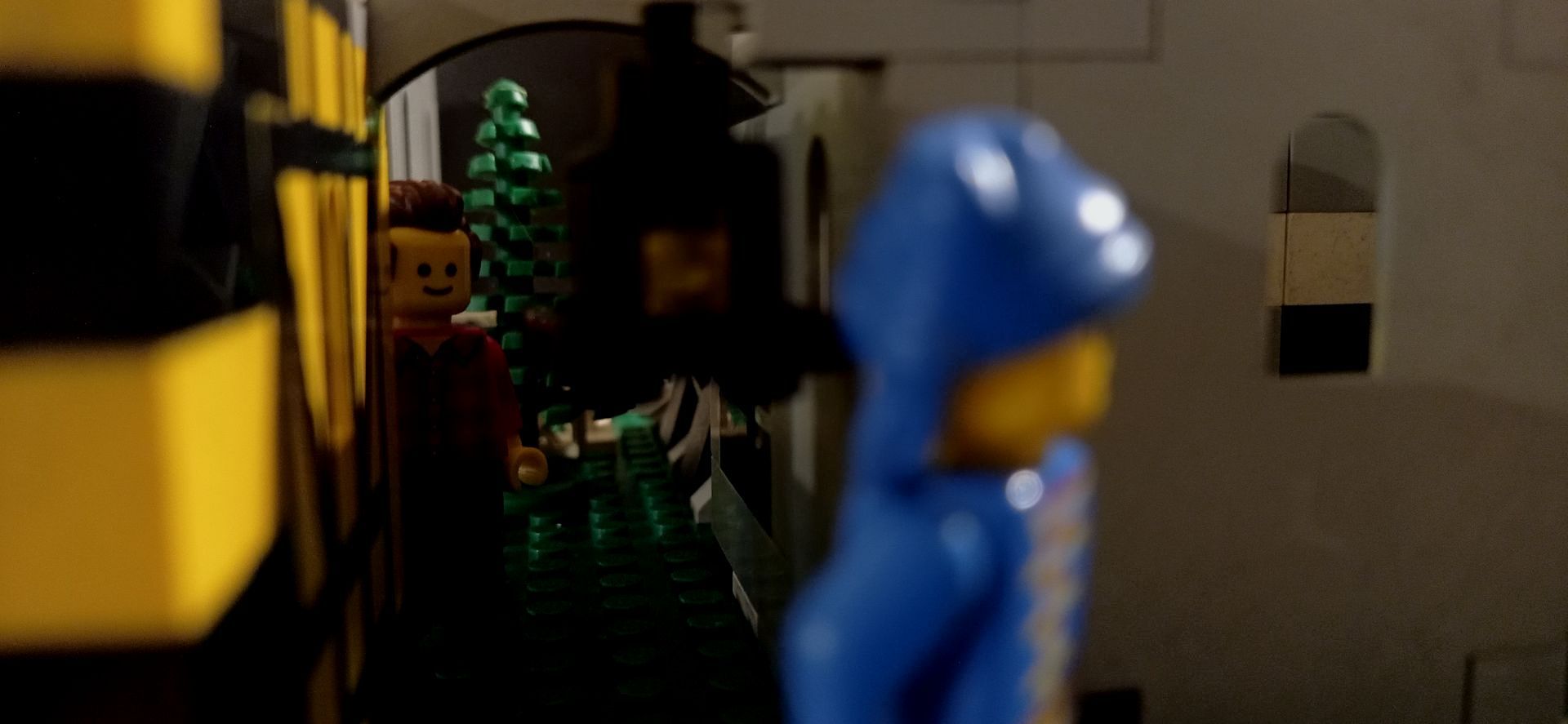 A blue lego figure is standing next to a yellow lego figure in a room.