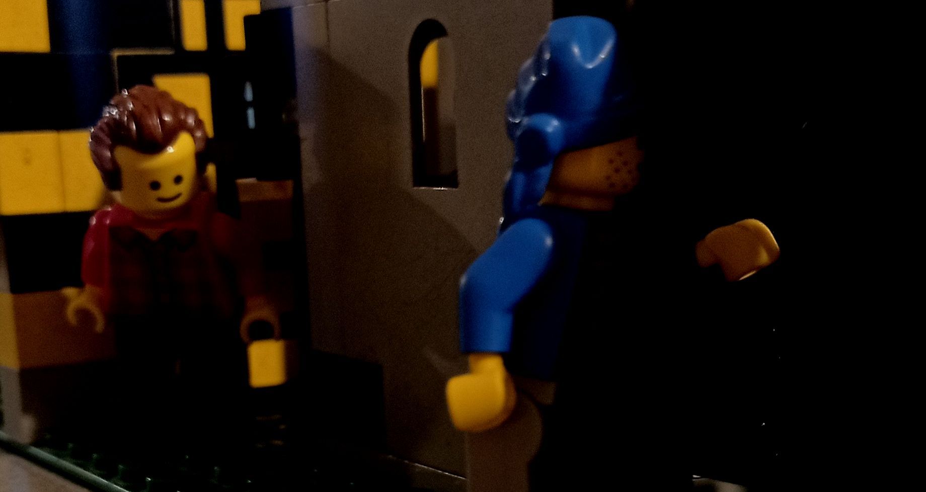 A couple of lego figures standing next to each other