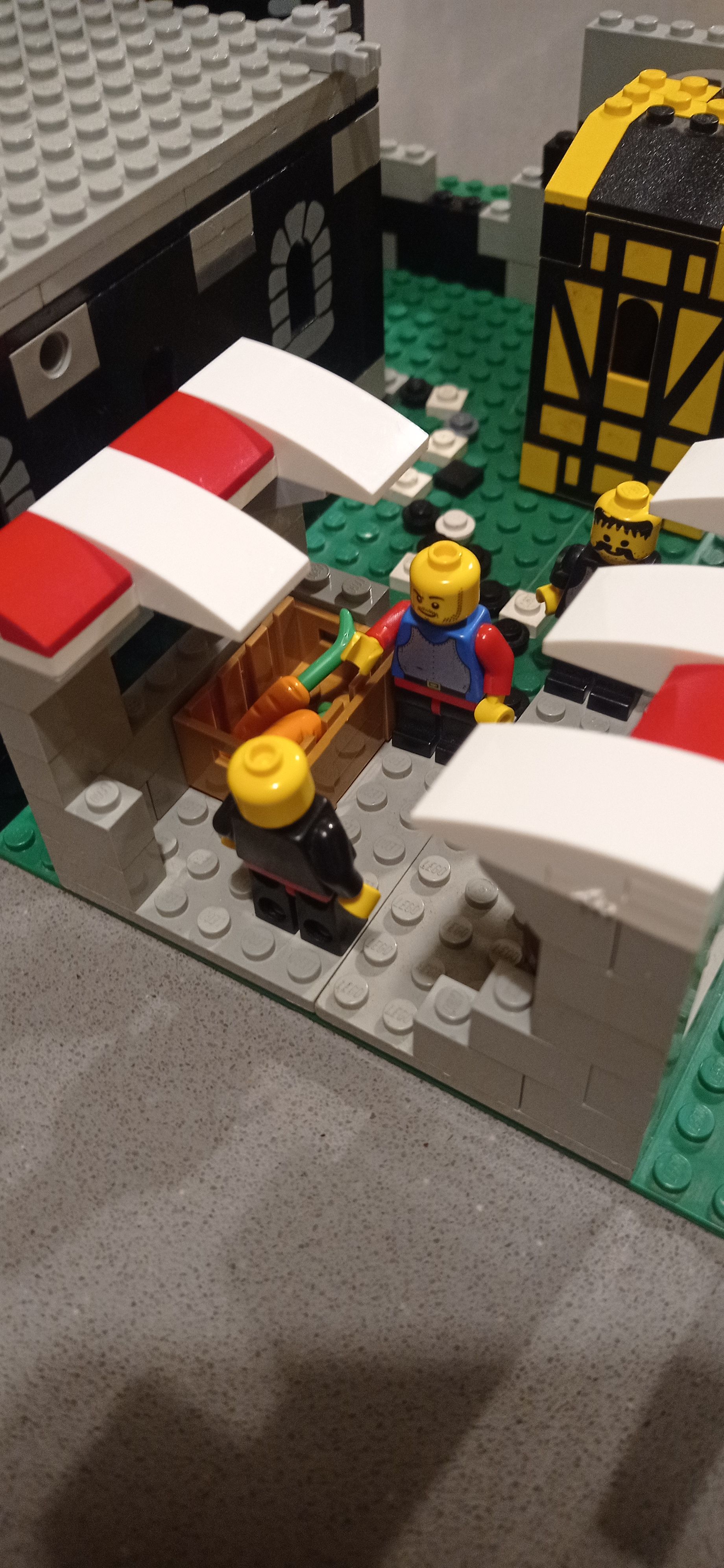 A group of lego figures are standing in front of a building.