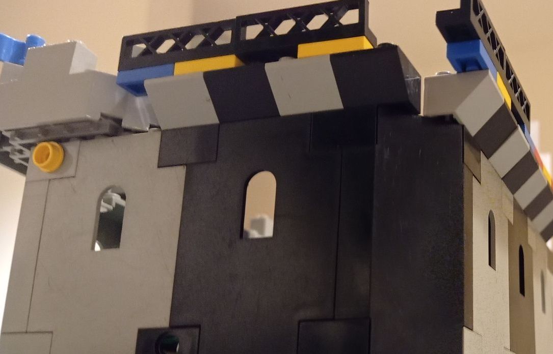 A black and white lego building with a window